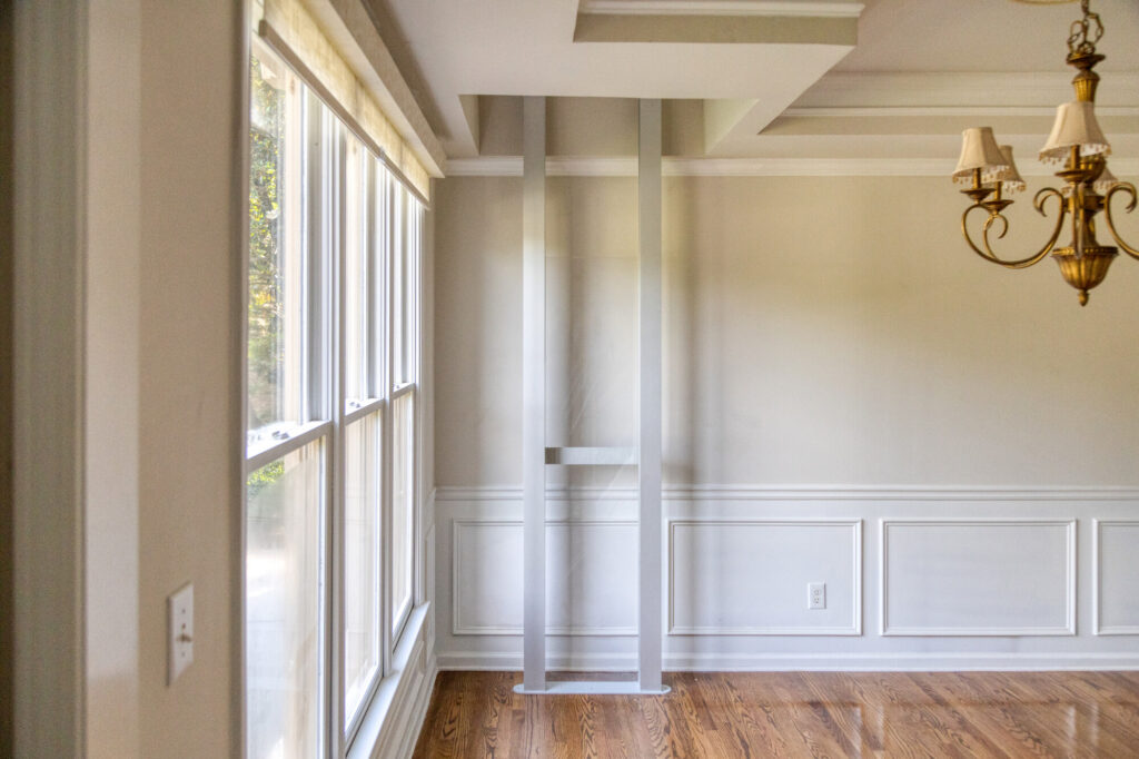 Residential elevator with open glass door in a beautifully maintained home