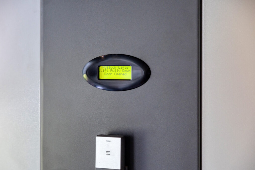 Close-up of residential elevator interior showing safety features and controls