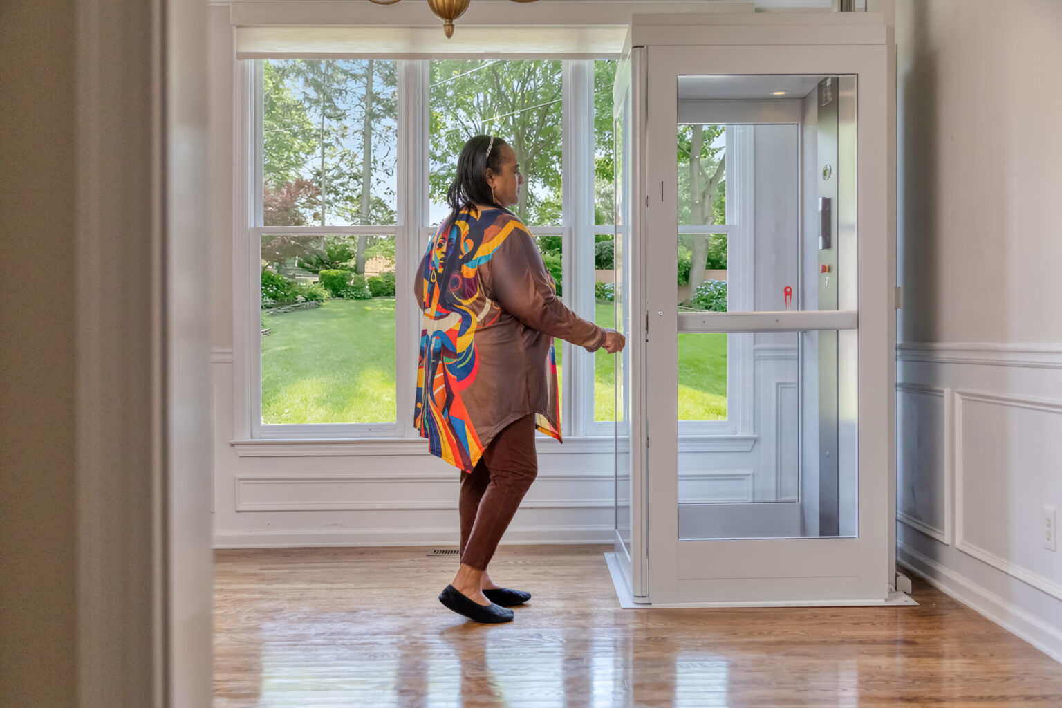 Residential elevator installation in a beautifully finished home with hardwood floors